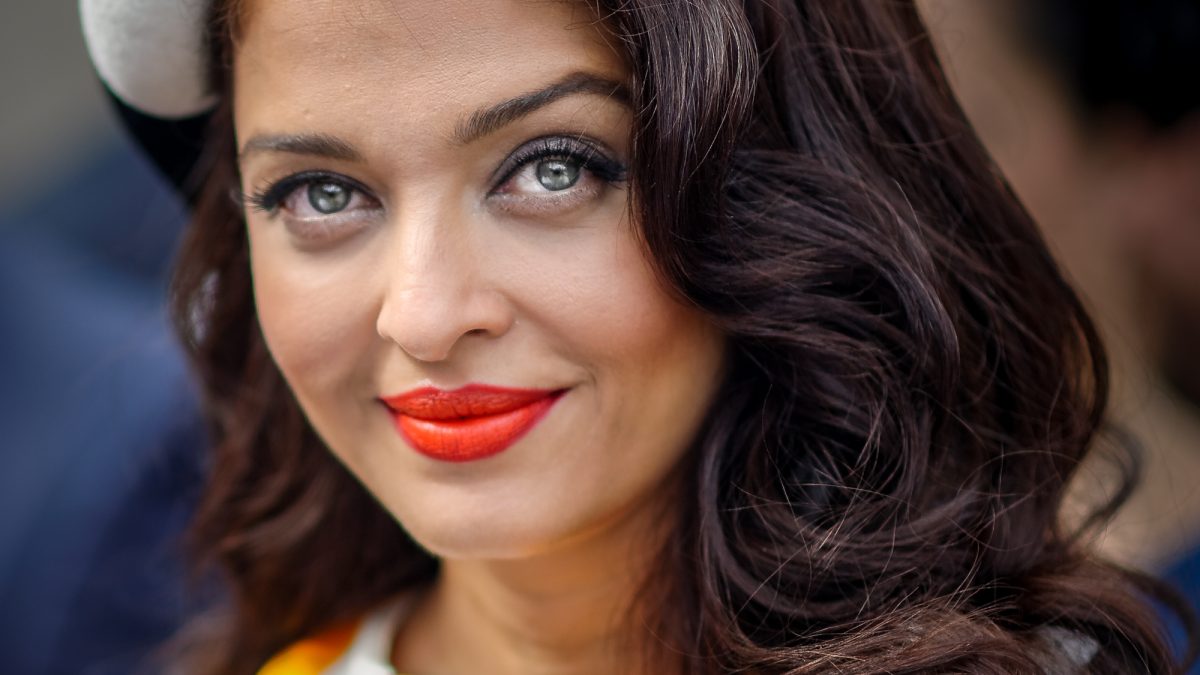 Aishwarya Rai Bachchan with red lipstick and a grey fascinator at Royal Randwick racecourse in Sydney