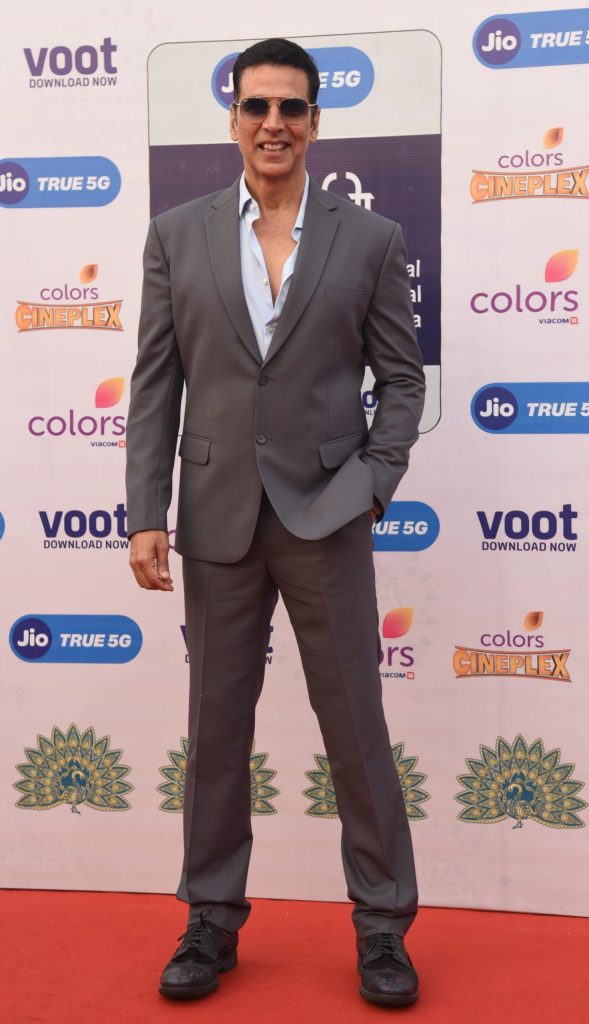 Akshay Kumar in a grey suit and sunglasses on the red carpet at the International Film Festival of India