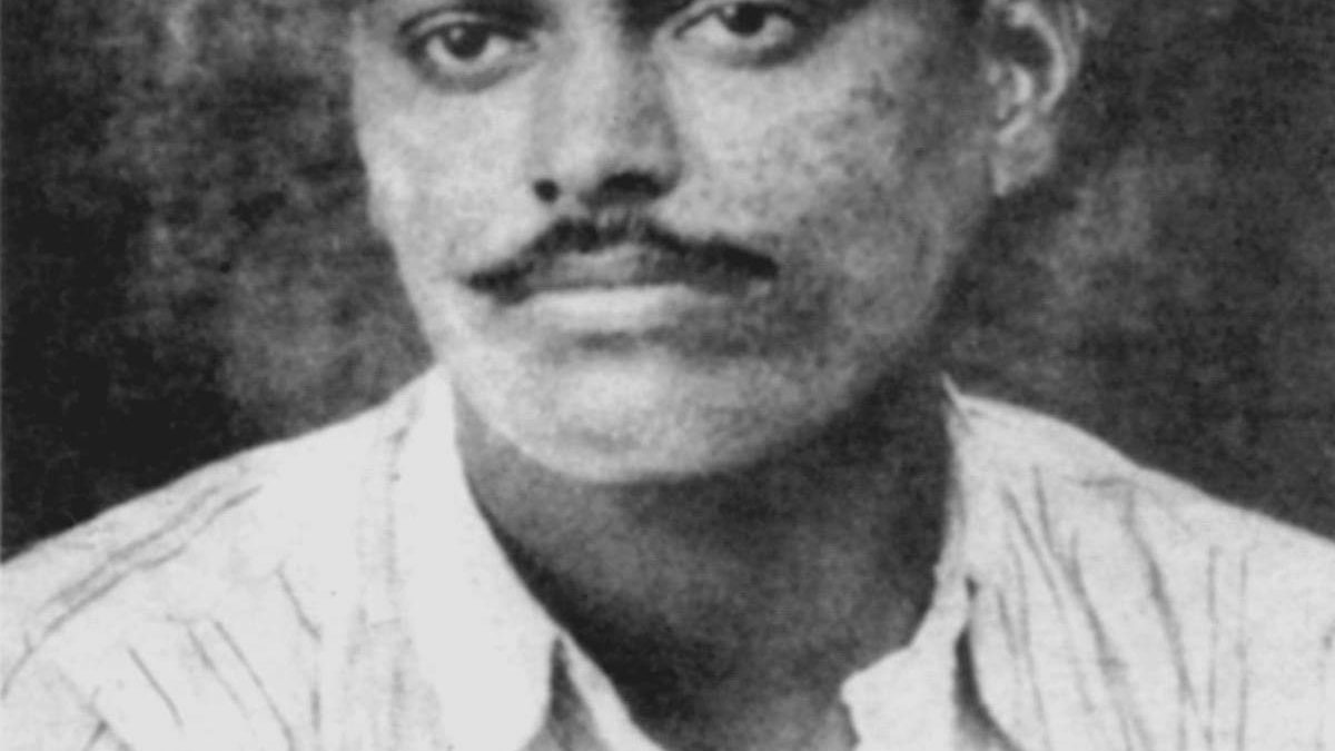 Black and white portrait of Chandrashekhar Azad in a striped shirt