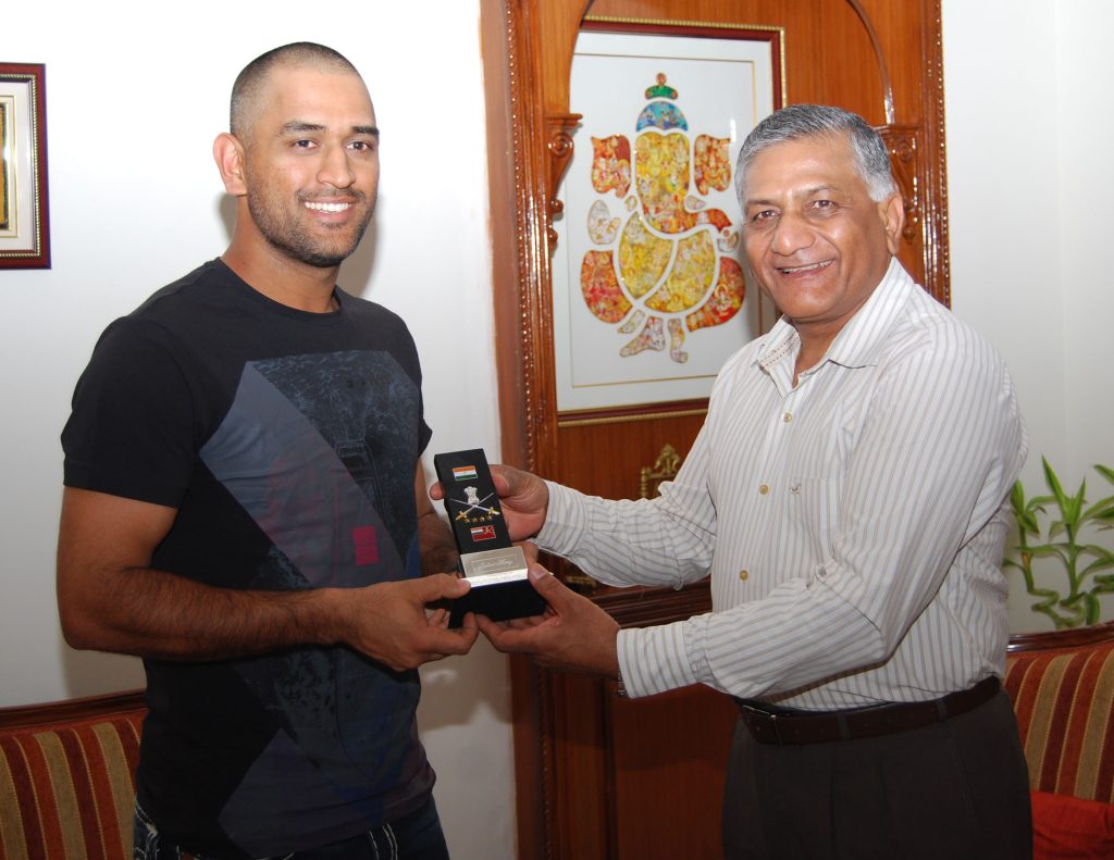 MS Dhoni receiving a memento from Army Chief General V.K. Singh in New Delhi, 2011