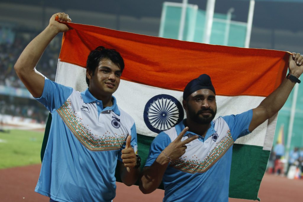 Neeraj Chopra and Davinder Singh Kang holding the Indian flag after a javelin event
