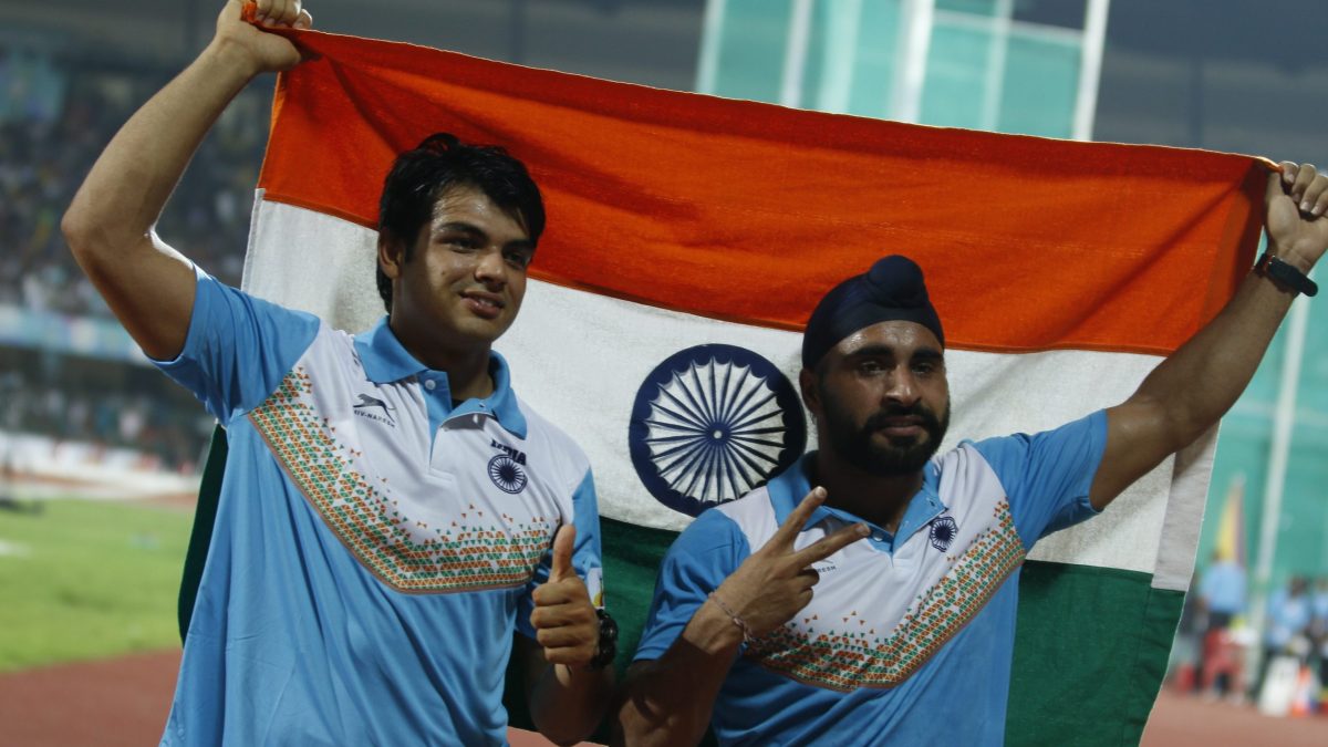 Neeraj Chopra and Davinder Singh Kang holding the Indian flag after a javelin event