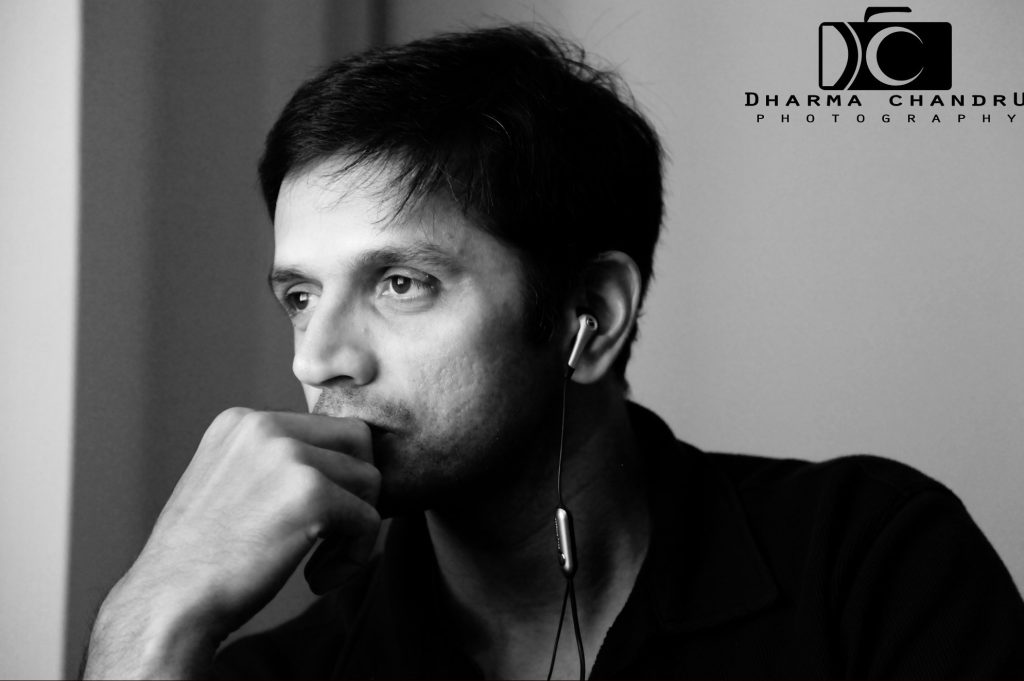 Black-and-white portrait of Rahul Dravid resting his chin on his hand