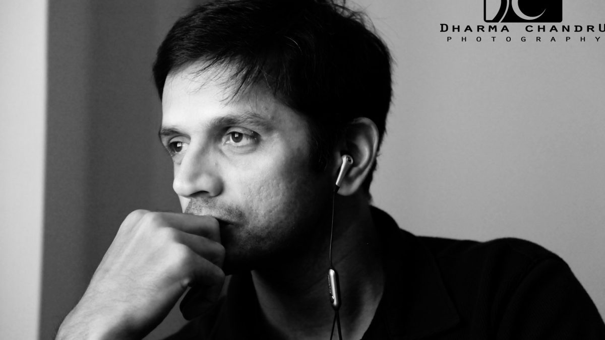 Black-and-white portrait of Rahul Dravid resting his chin on his hand