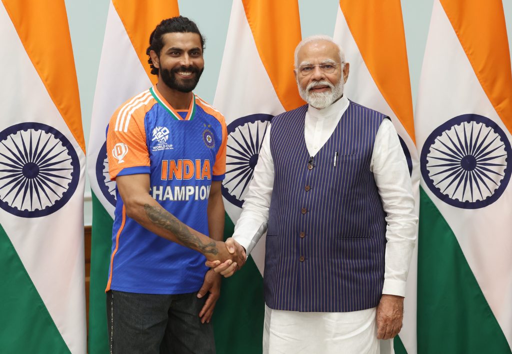 Ravindra Jadeja in an India Champions jersey shaking hands with Prime Minister Narendra Modi