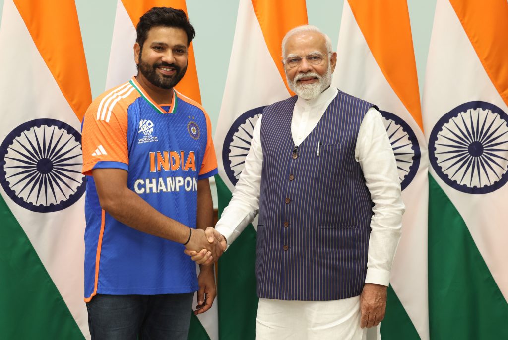 Rohit Sharma in an India Champions jersey shaking hands with Prime Minister Narendra Modi