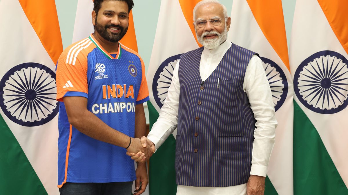 Rohit Sharma in an India Champions jersey shaking hands with Prime Minister Narendra Modi