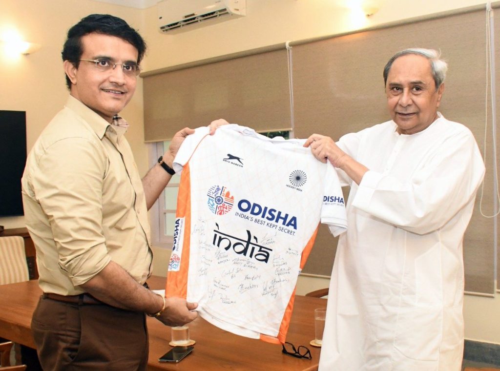 Sourav Ganguly holding an India hockey jersey with Naveen Patnaik