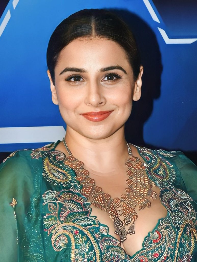 Vidya Balan smiling with her hair tied back at the Dadasaheb Phalke International Film Festival Awards