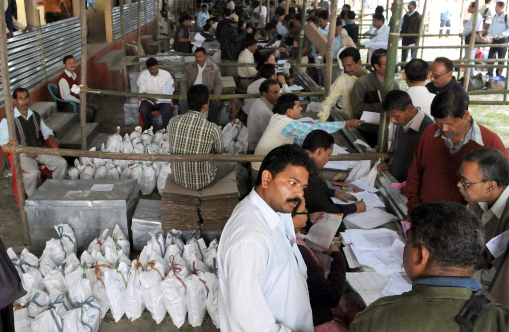 Polling officers receiving electronic voting machines and election materials in Assam