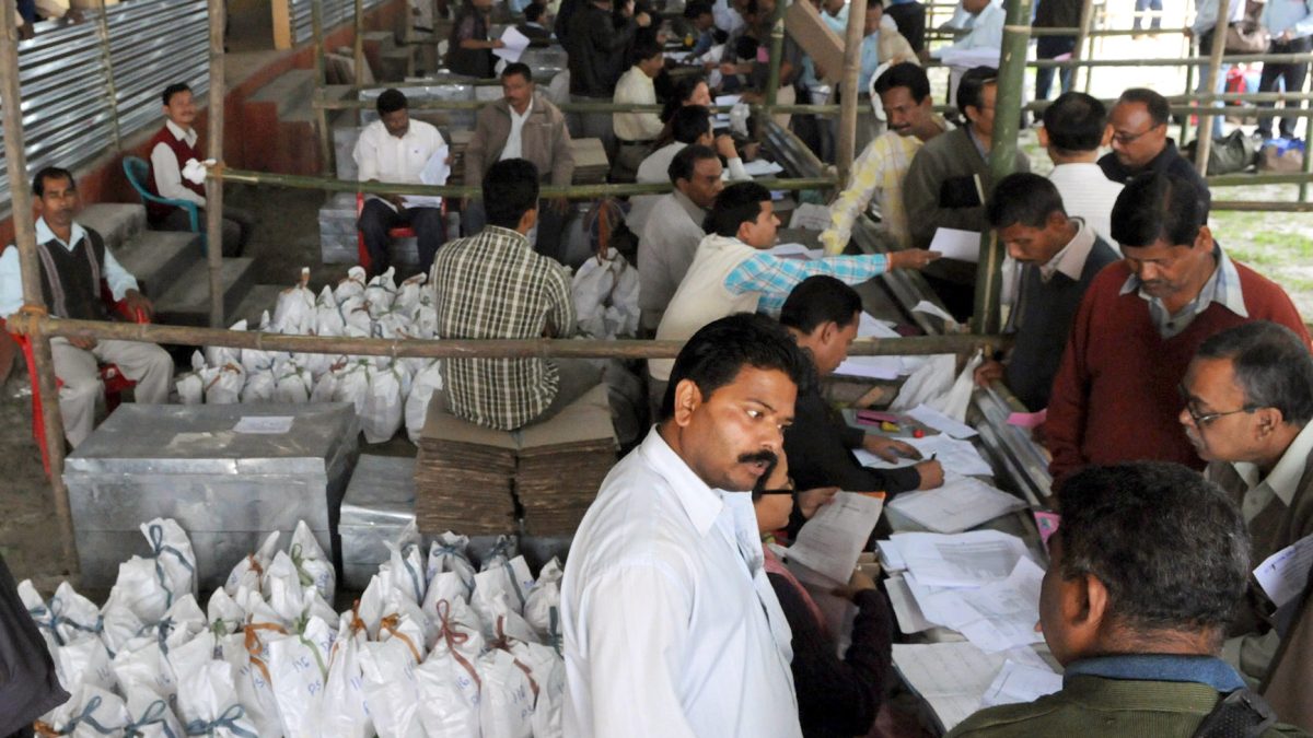 Polling officers receiving electronic voting machines and election materials in Assam