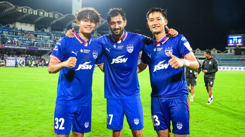 Three Bengaluru FC players celebrate after a match
