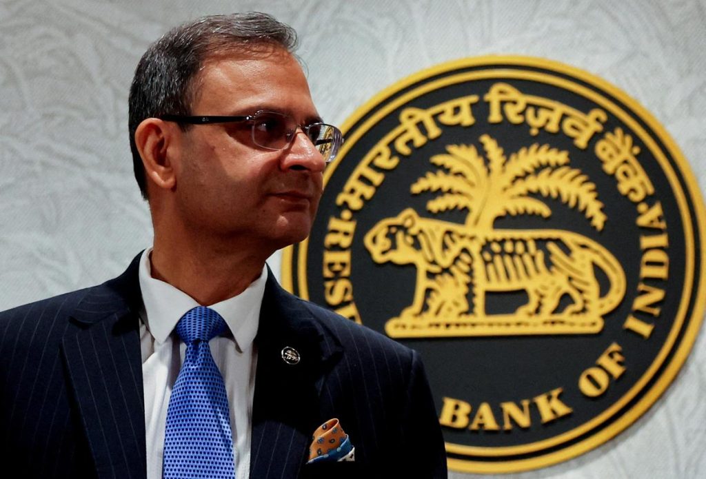 A man standing in front of the Reserve Bank of India emblem
