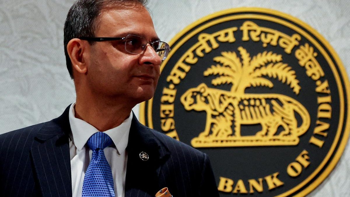 A man standing in front of the Reserve Bank of India emblem