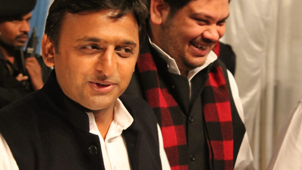 Akhilesh Yadav smiling, with another man beside him