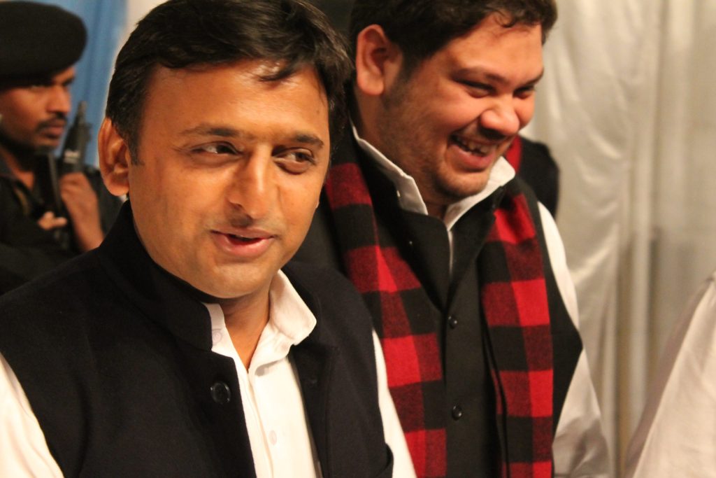Akhilesh Yadav smiling, with another man beside him