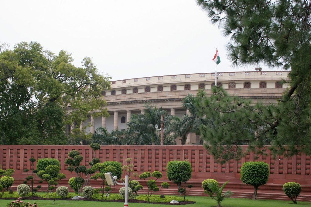 The Sansad Bhavan building in New Delhi seen through trees