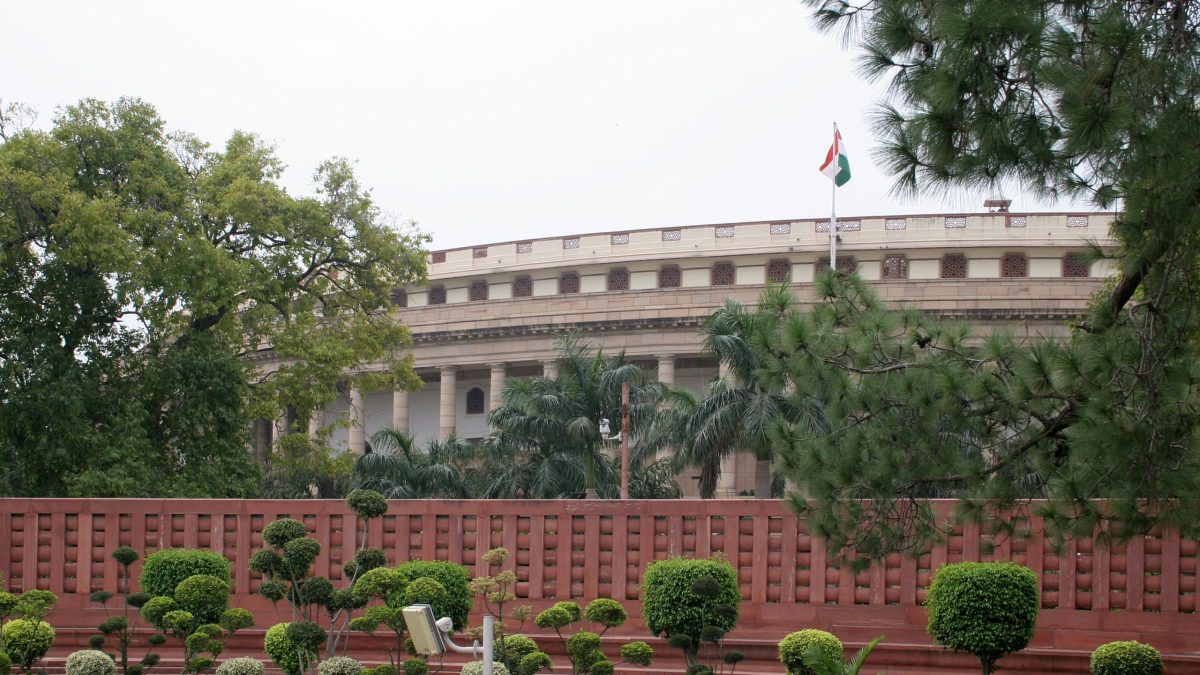 The Sansad Bhavan building in New Delhi seen through trees