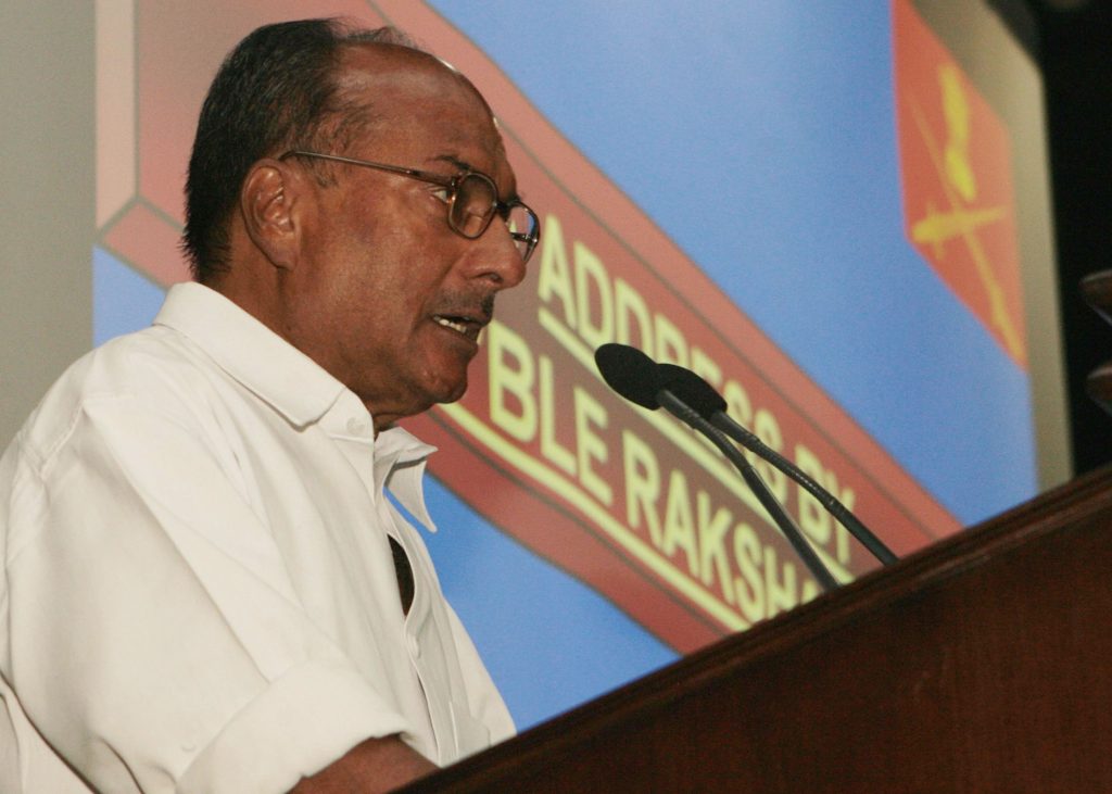 A. K. Antony in a white shirt speaking at a conference