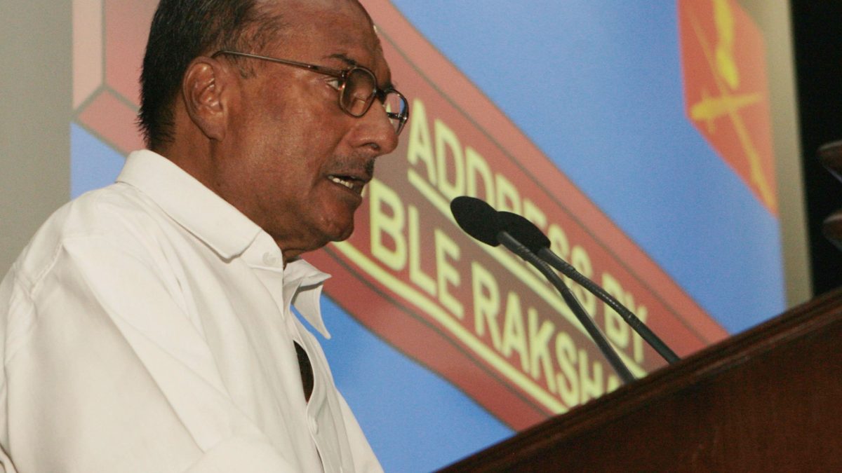 A. K. Antony in a white shirt speaking at a conference