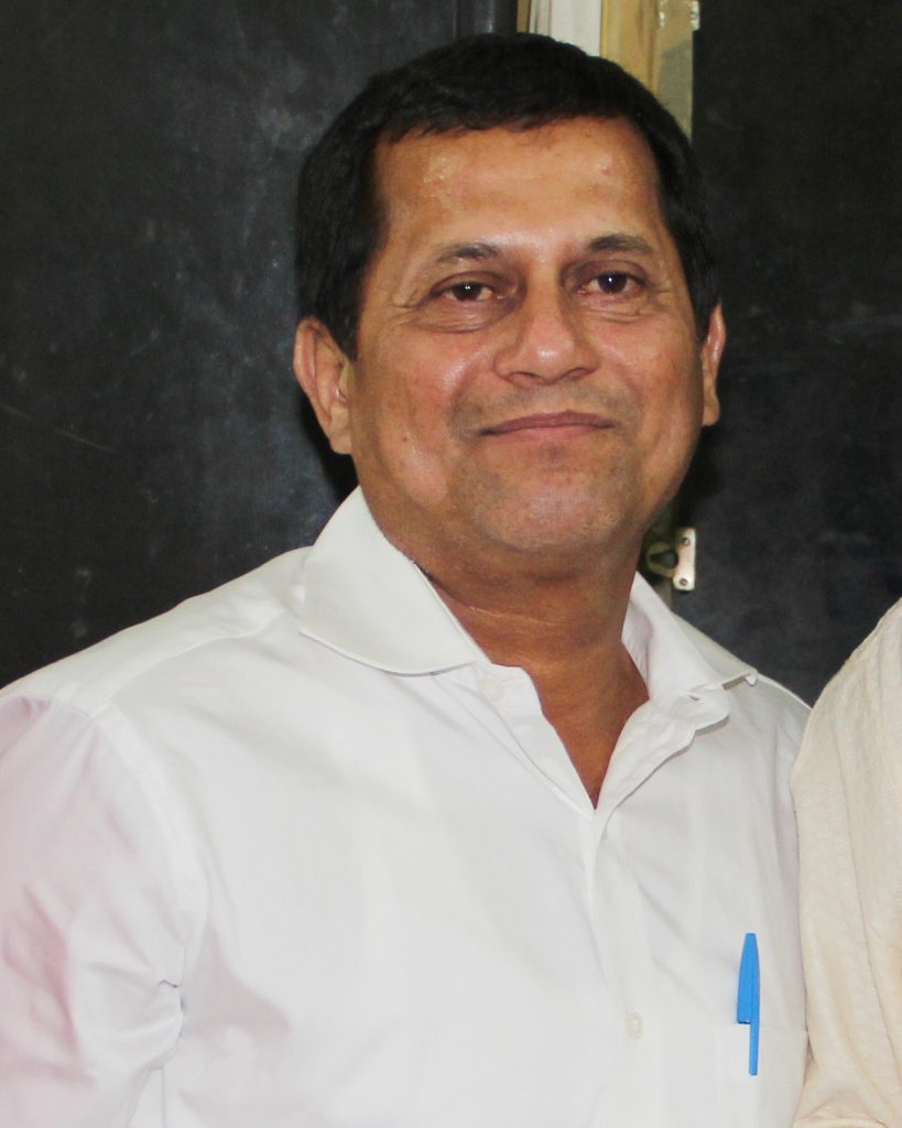 Achyuta Samanta in a white shirt, smiling