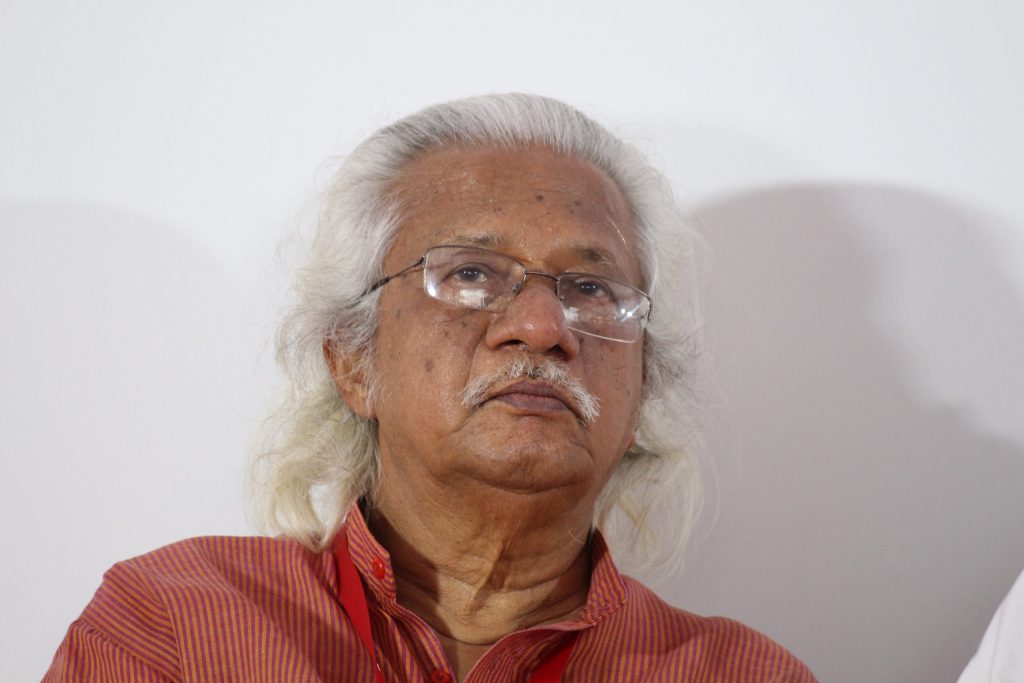 Close-up of Adoor Gopalakrishnan with white hair and glasses
