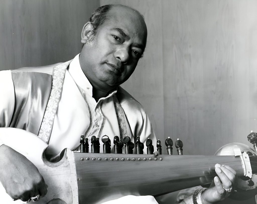 A black-and-white photograph of Ali Akbar Khan playing the sarod