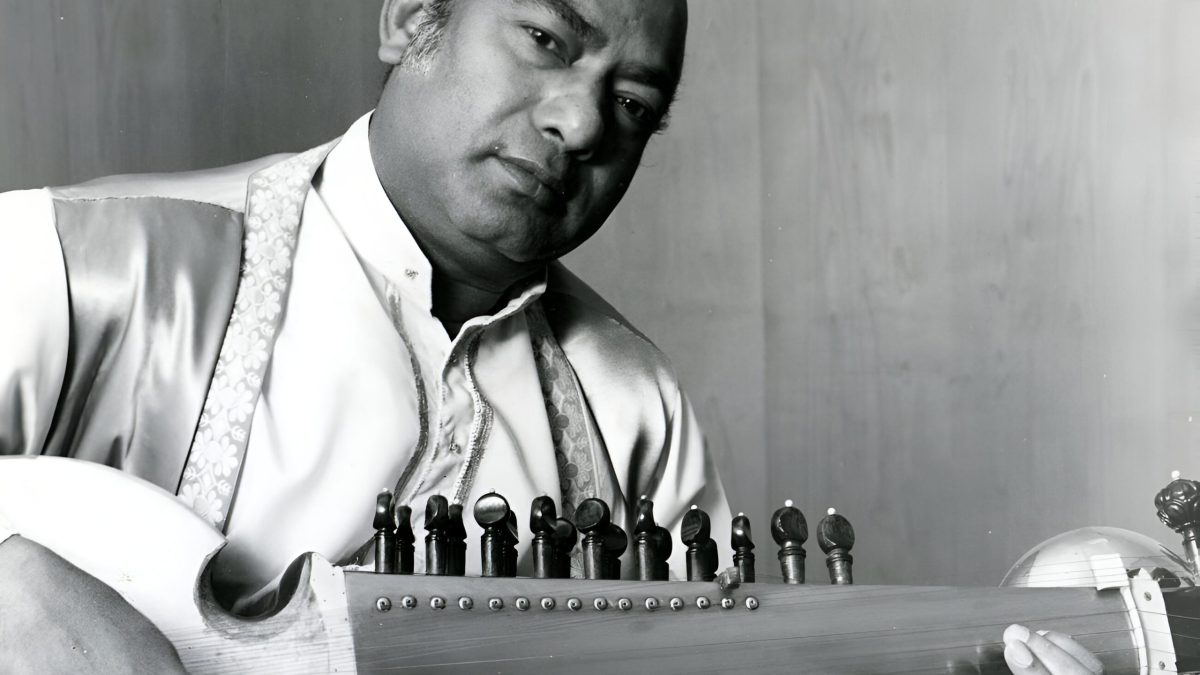 A black-and-white photograph of Ali Akbar Khan playing the sarod