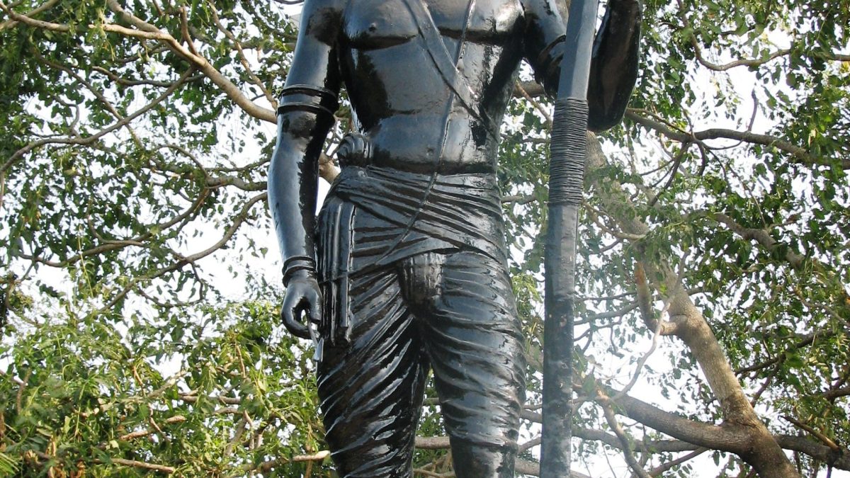 A bronze statue of Alluri Sitarama Raju holding a bow
