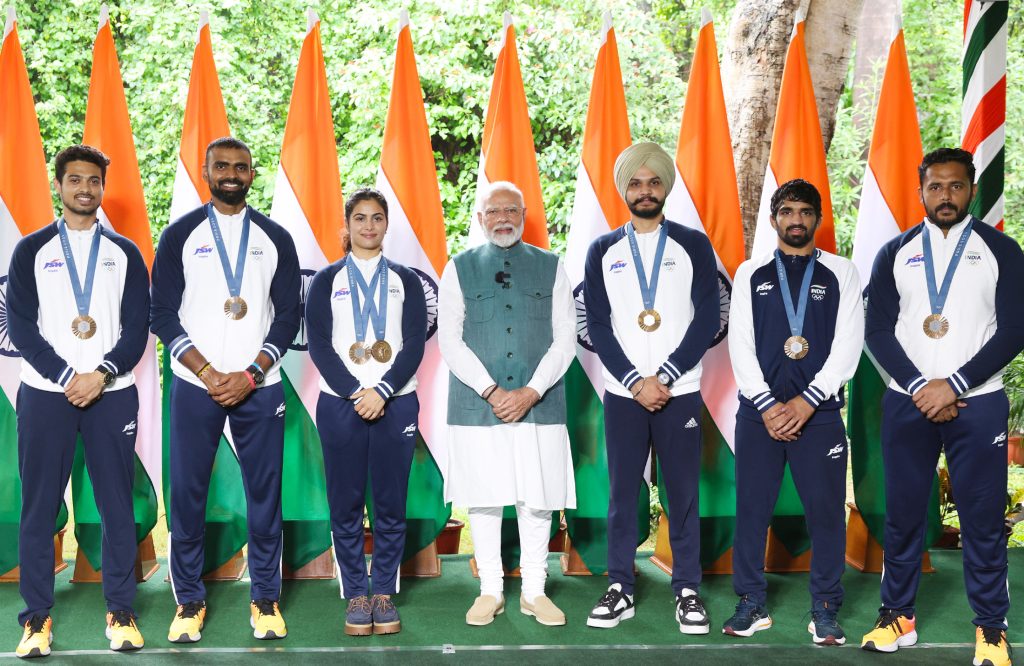 India's Paris Olympics medal winners standing with the Prime Minister