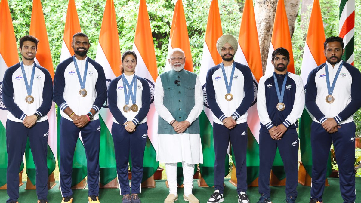 India's Paris Olympics medal winners standing with the Prime Minister