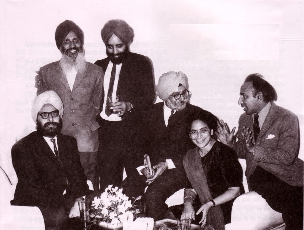 A black-and-white group photograph of Amrita Pritam seated among five Punjabi writers