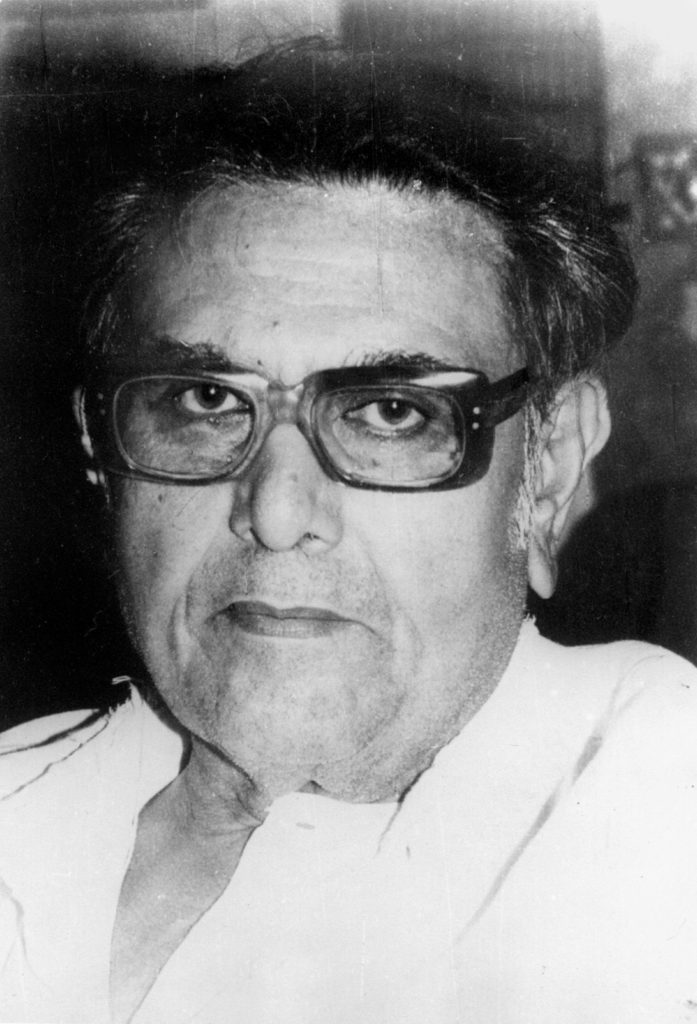 Black-and-white close-up of Amritlal Nagar in heavy-framed glasses