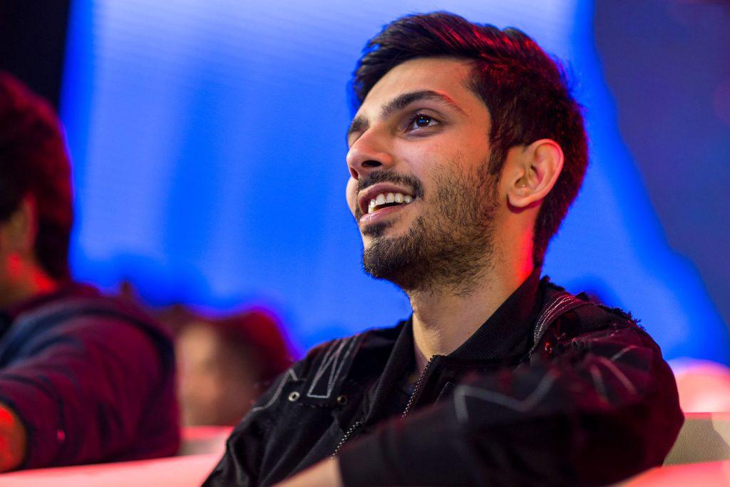 Anirudh Ravichander smiling in a black jacket at a film music launch