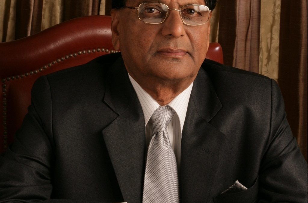 K. Anji Reddy in glasses and a dark suit, seated