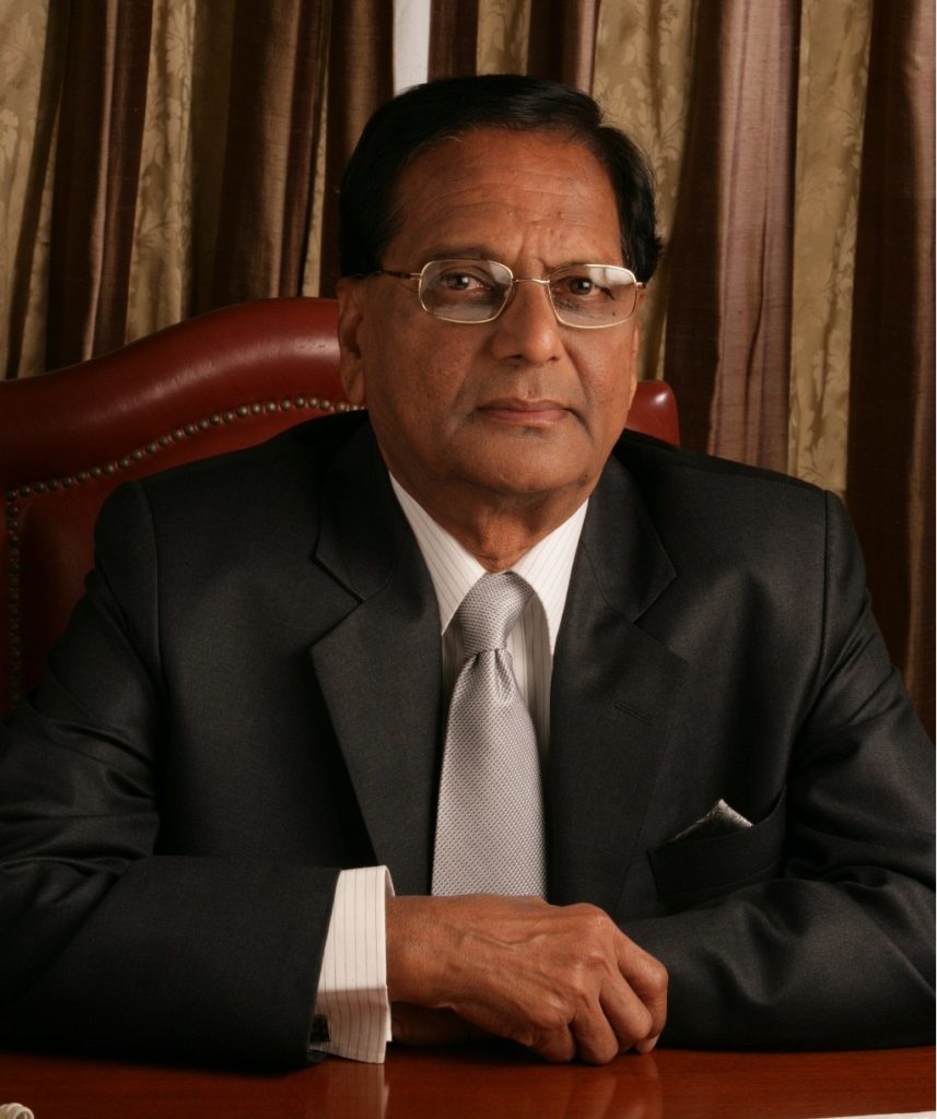 K. Anji Reddy in glasses and a dark suit, seated