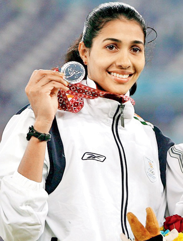 Anju Bobby George in an India vest at an athletics stadium