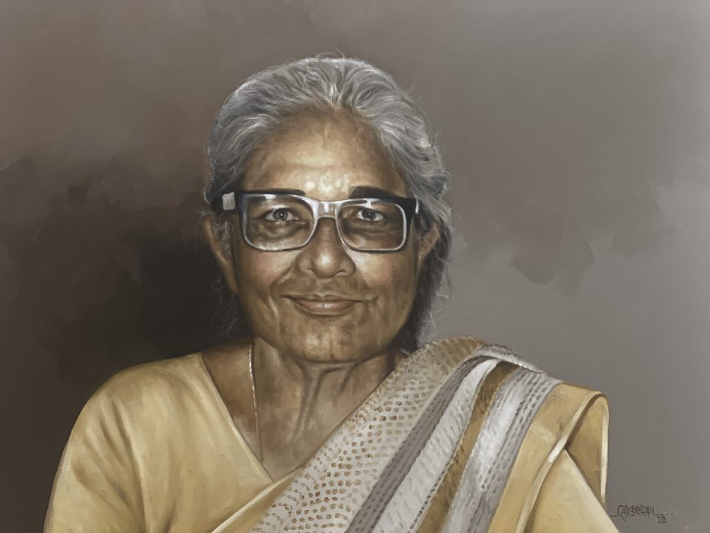 An oil painting of an elderly Anna Mani with grey hair and glasses, smiling