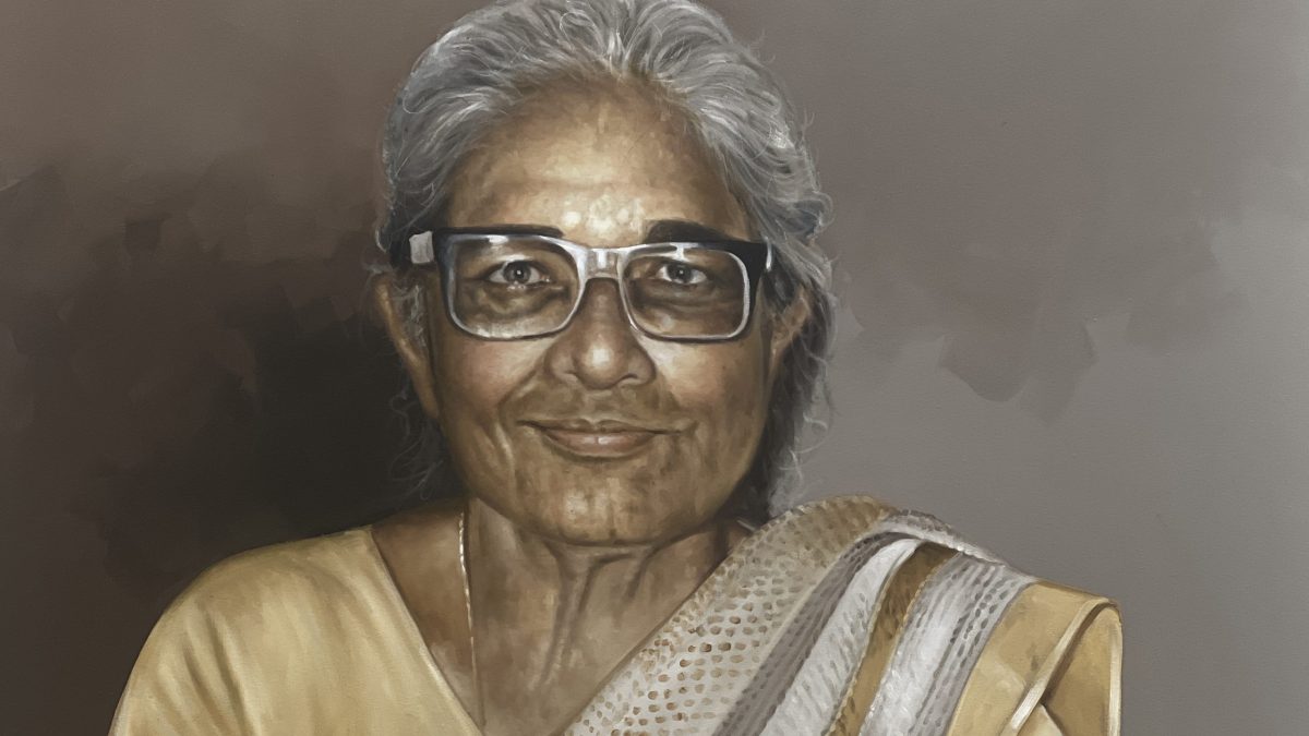 An oil painting of an elderly Anna Mani with grey hair and glasses, smiling