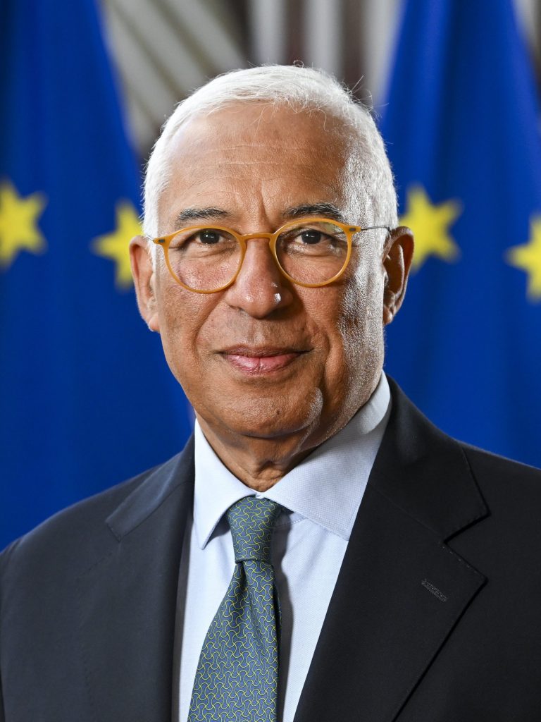 Portrait of António Costa in glasses and a dark suit, smiling
