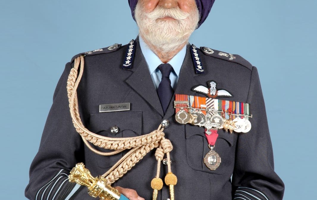 Arjan Singh in air force uniform with medals, holding his marshal's baton