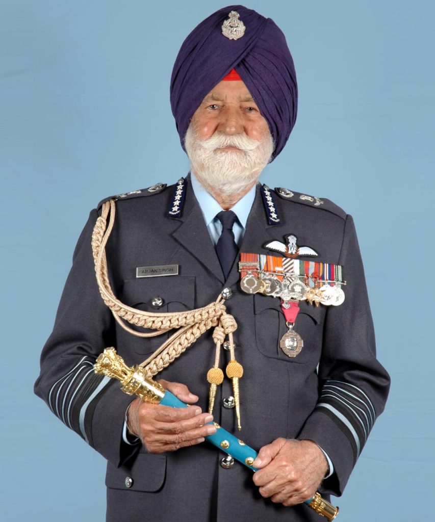 Arjan Singh in air force uniform with medals, holding his marshal's baton