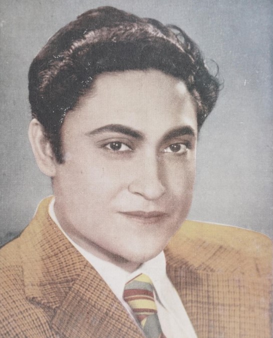 A portrait of the young Ashok Kumar in a jacket and tie
