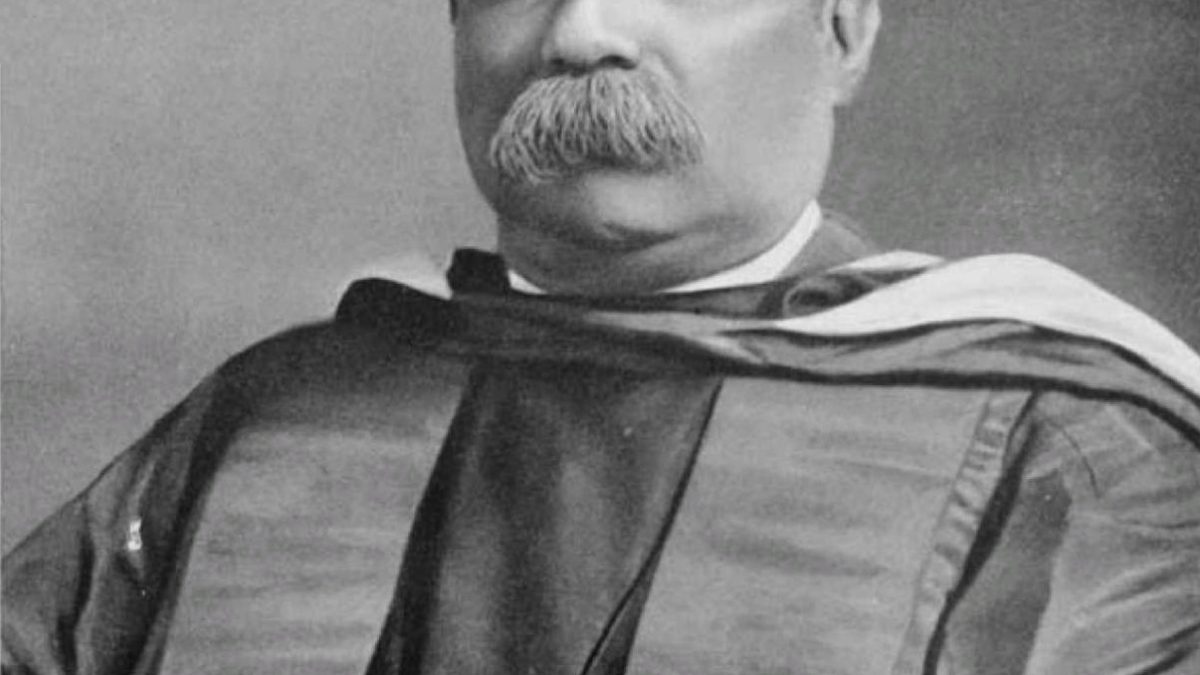 Black-and-white portrait of Ashutosh Mukherjee with a heavy moustache, in academic robes
