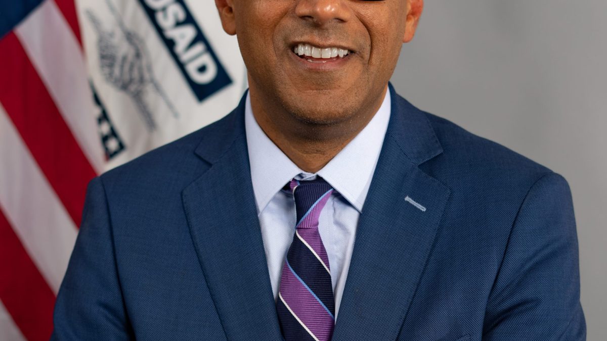 Official portrait of Atul Gawande in glasses and a dark suit