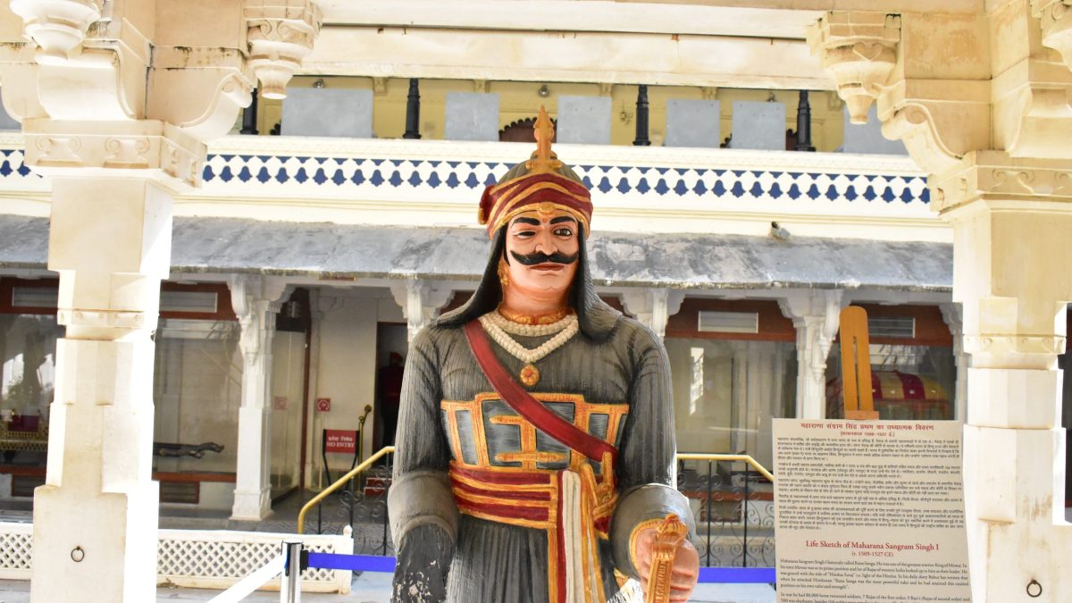 A painted statue of Rana Sanga in armour and turban standing in a courtyard of the City Palace in Udaipur