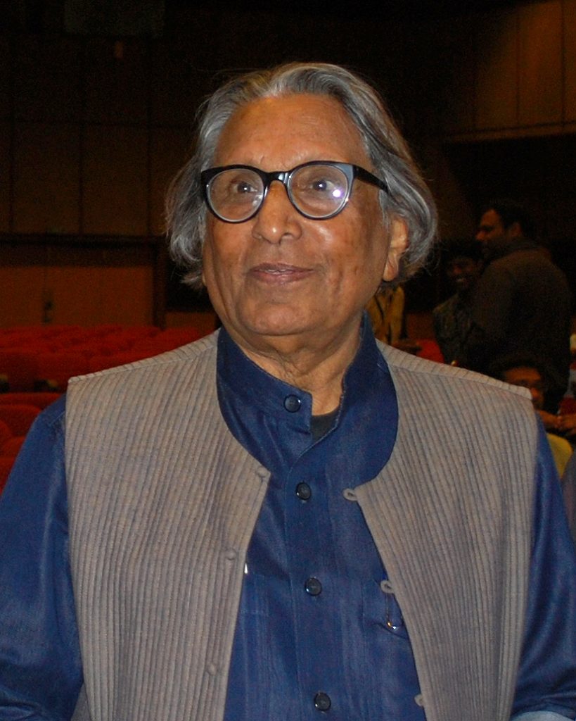 B. V. Doshi in glasses and a grey waistcoat