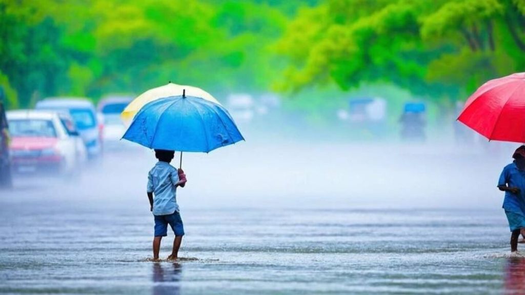 A child holding a blue umbrella walks along a rain-soaked road lined with green trees