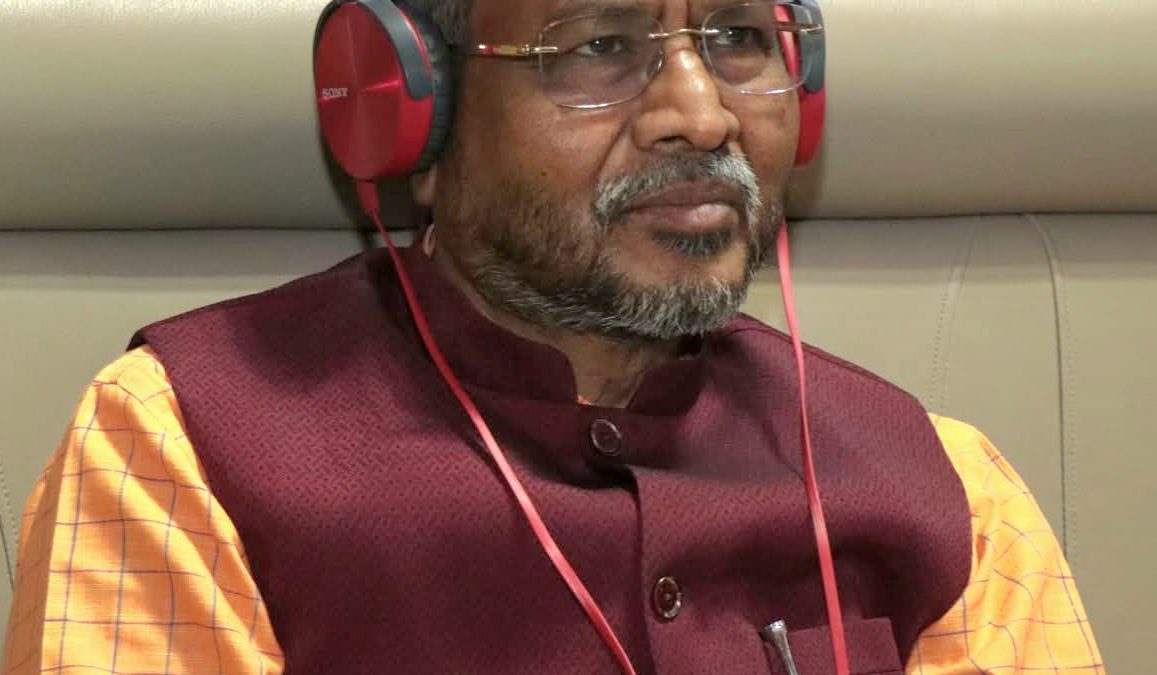 Babulal Marandi wearing headphones in the assembly, in a maroon waistcoat