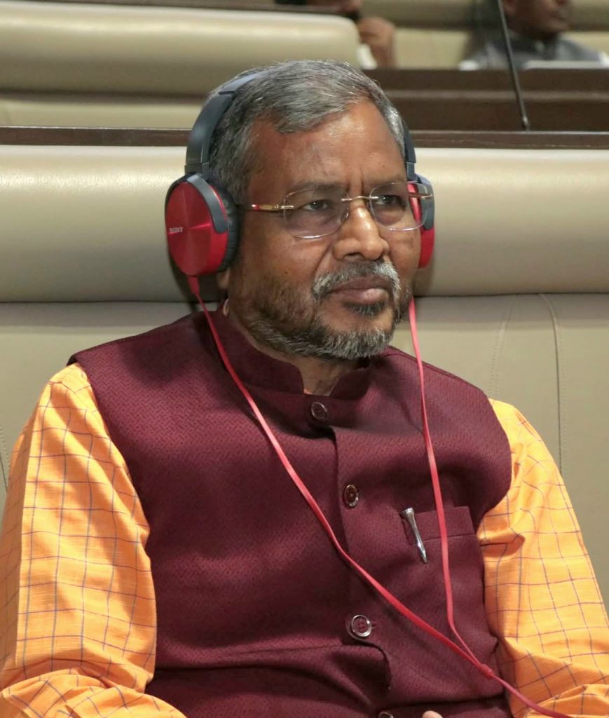 Babulal Marandi wearing headphones in the assembly, in a maroon waistcoat